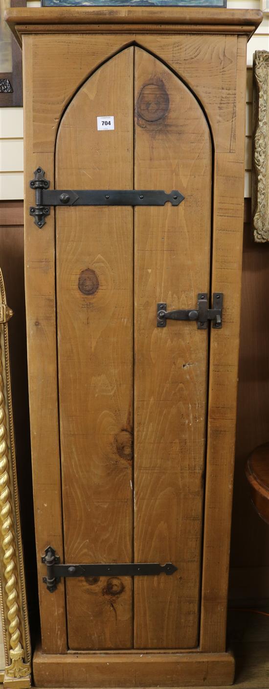 A narrow tall pine cupboard W.61cm